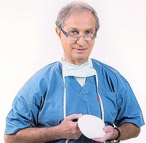 the doctor is holding a breast augmentation implant